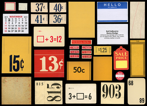 variety of labels,tags and other paper ephemera items against black