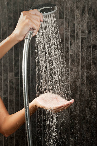 Testing the Shower Temperature (XXXL) Testing the Shower Temperature. Nikon D3X. Converted from RAW. woman hot shower stock pictures, royalty-free photos & images