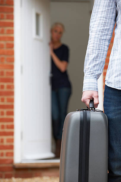 istock Man With Packed Suitcase Leaving Wife 182062810