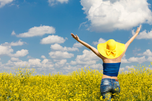 Young woman in canola field