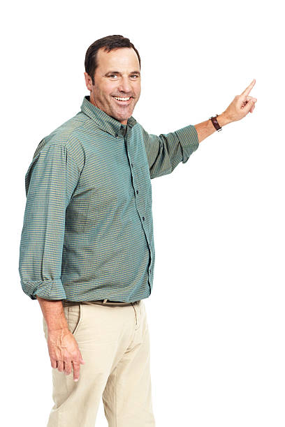 Happy mature man pointing into copyspace while isolated on white - portrait