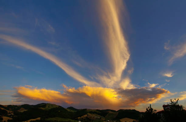 Panorama of clouds at sunset with strong color contrast