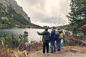 Father and sons hiking by the Popradské pleso in the High Tatra Mountains