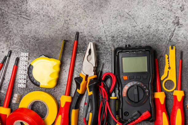 istock Electrician equipment on marble background with copy space.Top view.Electrician tool set.Multimeter, tester,screwdrivers,cutters,duct tape,lamps,tape measure and wires.Flet lay. 1820639868