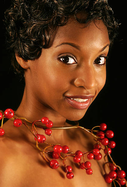 Woman in Cranberry young woman with a cranberry necklace - shot in studio modeldl stock pictures, royalty-free photos & images
