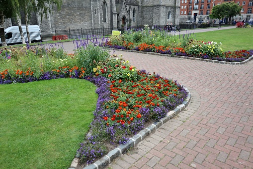 Dublin, Ireland – September 21, 2021: Flower beds in the gardens of the Gothic Cathedral dedicated to St. Patrick