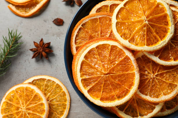 istock Dry orange slices and anise stars on grey table, flat lay 1820648610