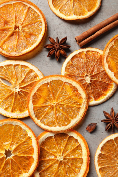 istock Dry orange slices, cinnamon sticks and anise stars on grey table, flat lay 1820650400