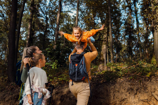 istock Smiling family of four exploring nature while hiking in forest. 1820654165
