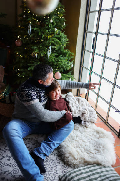 istock father and son playing near christmas tree 1820657087