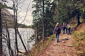 Family hiking by the lake in High Tatra Mountains,on an autumn day