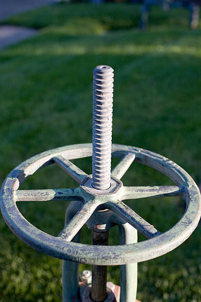 istock industrial valve detail with grass background 182066435
