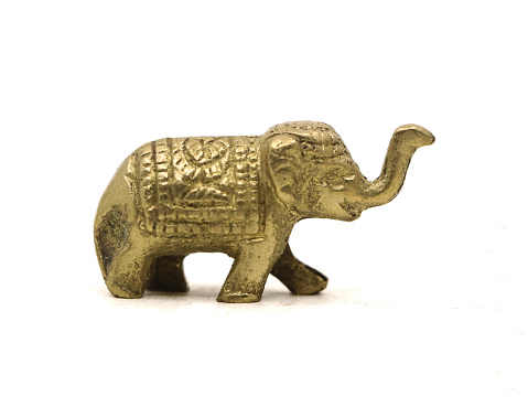 decorative elephant statue carved in bronze, ancient toy figure isolated in a white background