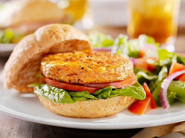 Vegetarian Soy Burger with Spinach "Vegetarian Soy Burger with Spinach, Tomatoes and a Side Salad -Photographed on Hasselblad H3D-39mb Camera" veggie burger photos stock pictures, royalty-free photos & images