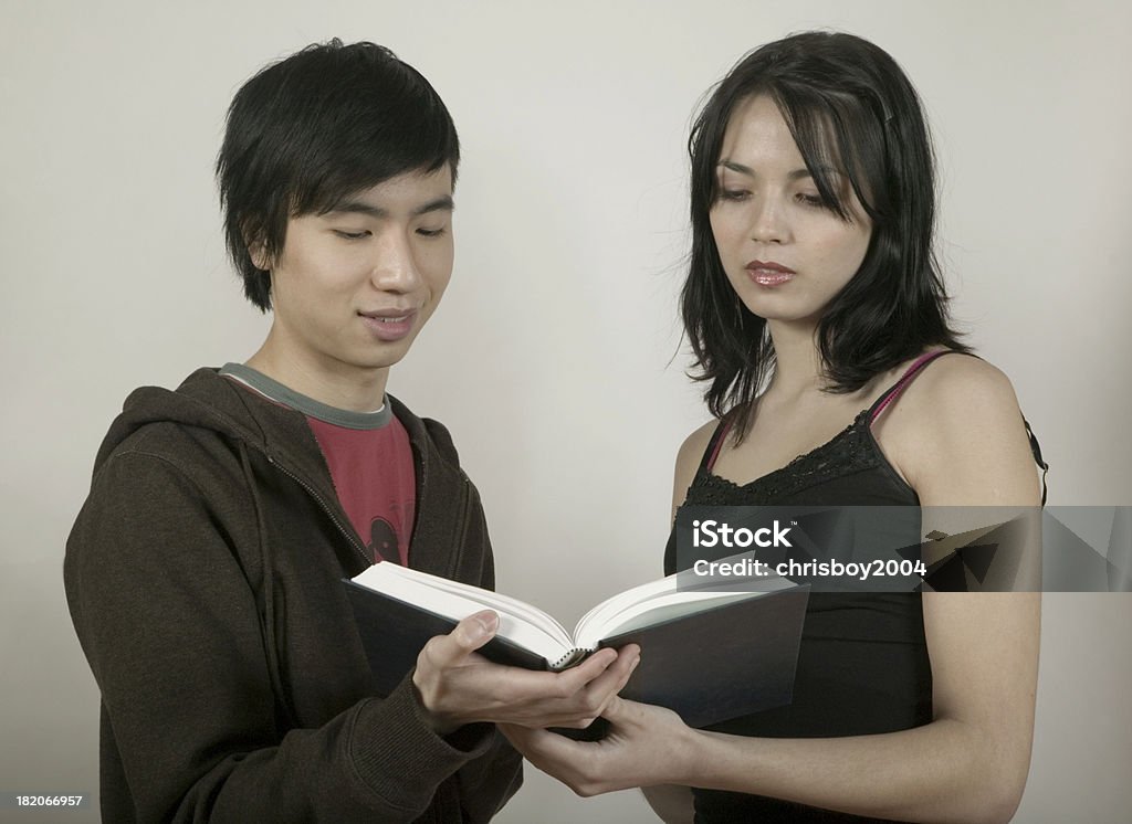 Reading "young adult male, and a female, reading a bookmore of this model" Adult Stock Photo