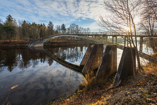 Arched bridge over Ogre river in autumn day Ogre, Latvia