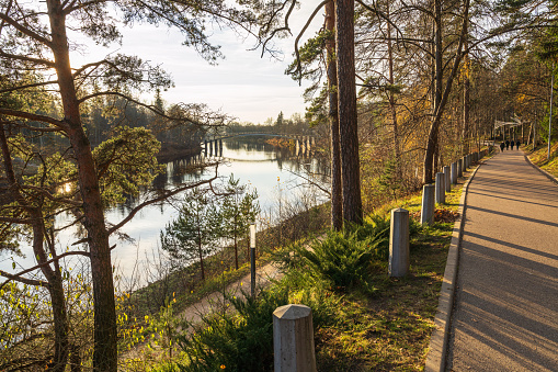 Park and pedestrian bridge  over Ogre river in autumn day Ogre, Latvia