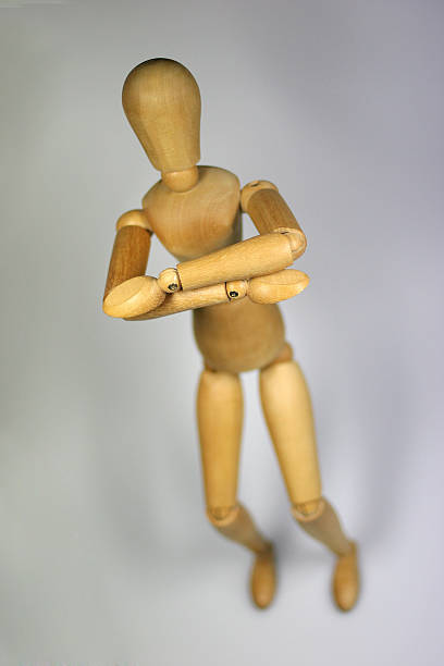istock Wooden human figurine posing 182069916