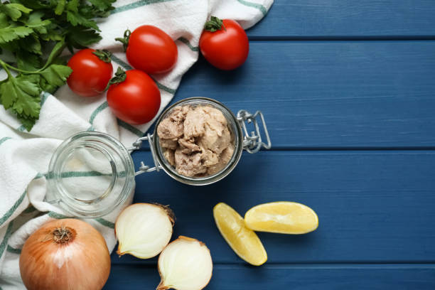 istock Flat lay composition with tasty cod liver and different products on blue wooden table. Space for text 1820707413