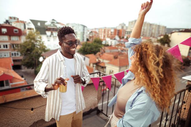 istock Young multiracial couple enjoying their time together on rooftop 1820717739