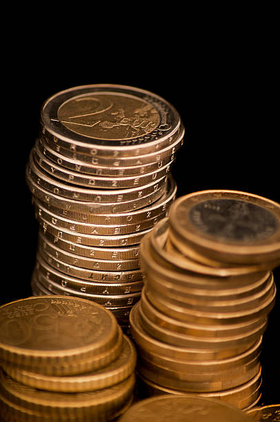 istock Euro coins isolated on black background 182072544