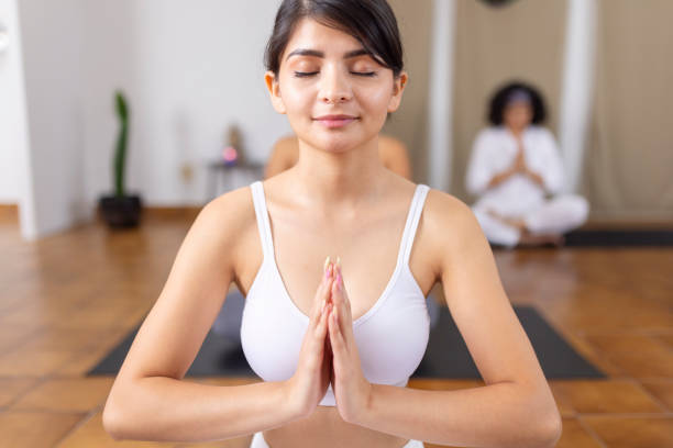istock Young woman meditating with hands close to heart 1820729406