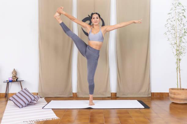 istock Happy woman practising yoga and testing her balance 1820731104