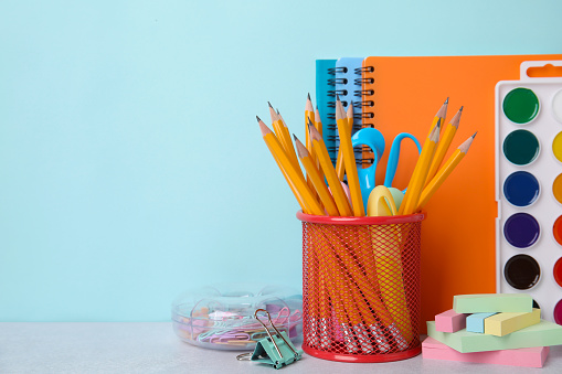 Different school stationery on table against light blue background, space for text. Back to school