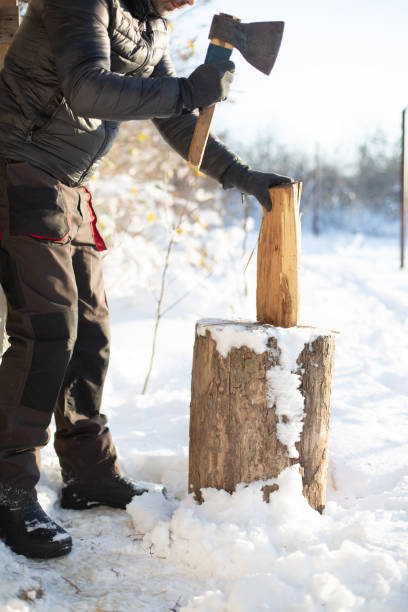 istock unrecognizable man's hands chopping wood in the winter snowy environment 1820751878