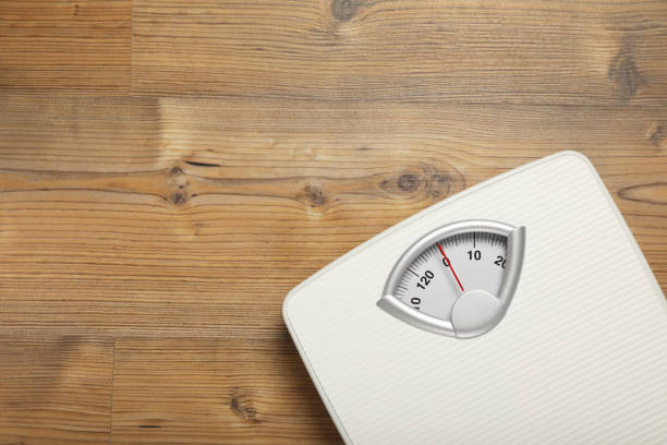 istock Scales on wooden floor, top view. Space for text 1820754614