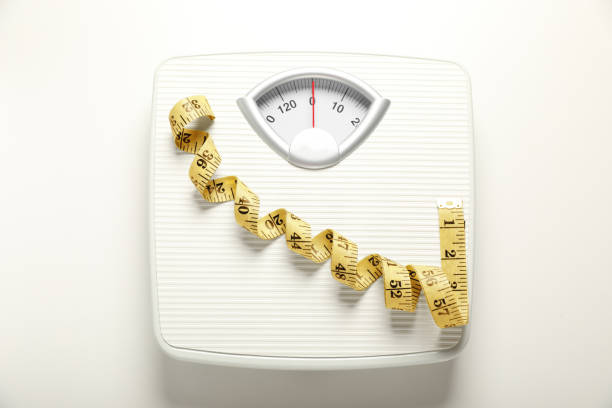 istock Scales and measuring tape on white background, top view 1820754948