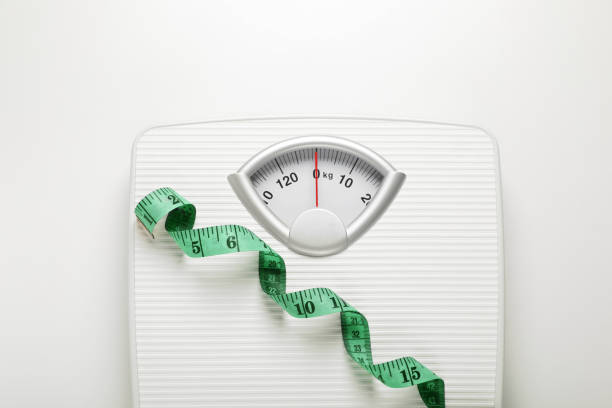 istock Scales and measuring tape on white background, top view 1820755748