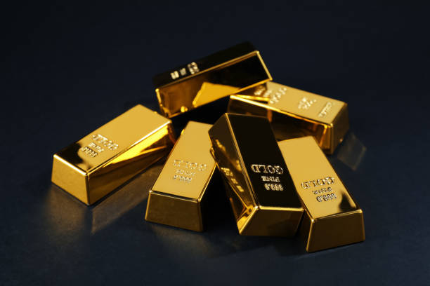 istock Many shiny gold bars on black background 1820760080