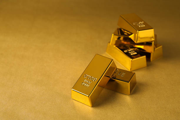 istock Many shiny gold bars on color background. Space for text 1820760613