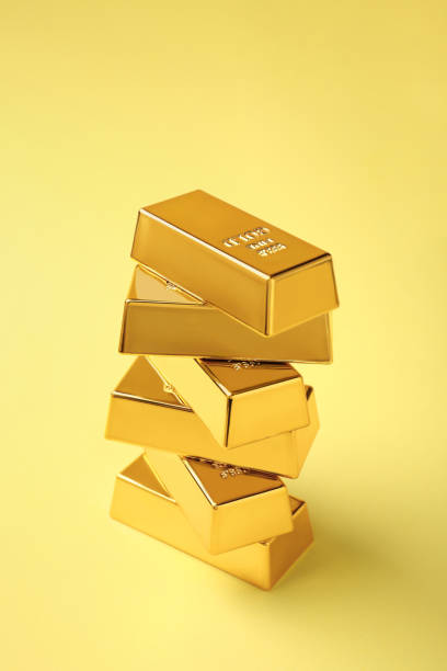 istock Stack of shiny gold bars on yellow background 1820762315