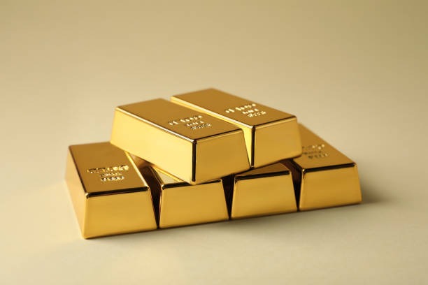istock Many shiny gold bars on beige background 1820762831