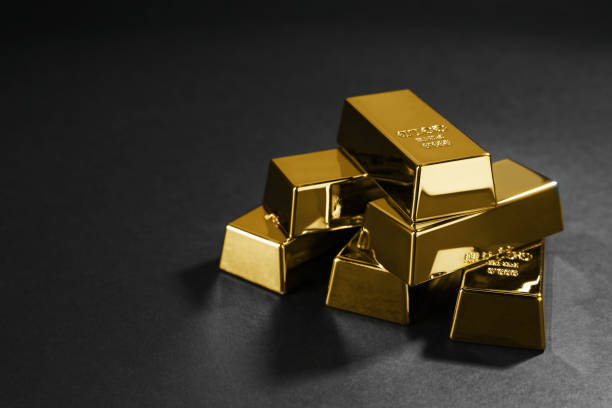 istock Many shiny gold bars on black background. Space for text 1820762859