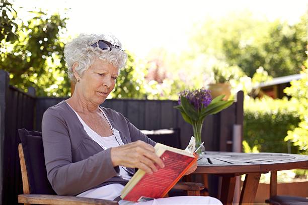 istock Senior woman reading book 182076960