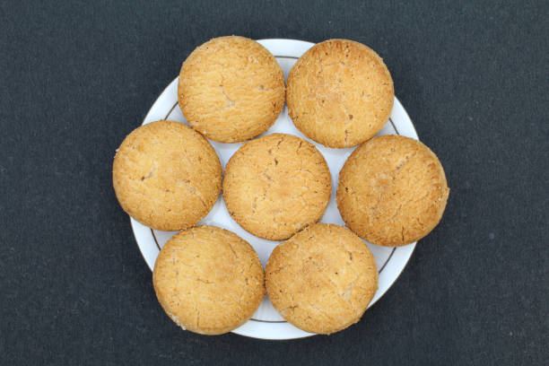 istock Osmania biscuits in a plate on black background top view 1820779135