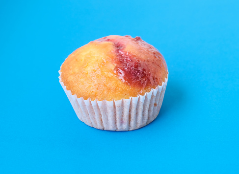 cupcake dessert with jam on blue background