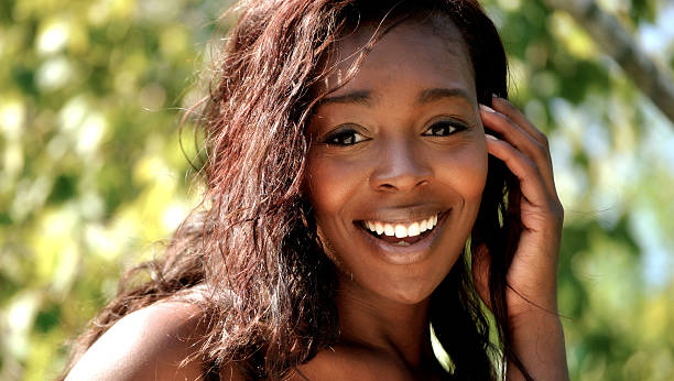istock happy young lady smiles for the camera 182079646