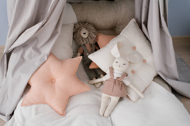istock Various pillows: square and sprocket, soft toys on the children's bed 1820796697