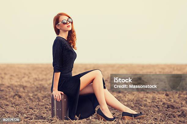 Fashion Redhead Women With Suitcase At Autumn Field Stock Photo - Download Image Now