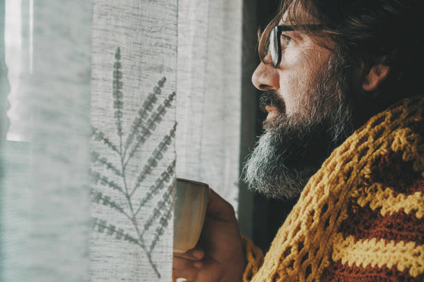 istock One man suffering cold temperature condition inside home for gas energy saving and price bills. Side view of male people drinking coffee or tea. Influenza flu cold symptoms and bad health condition 1820800506