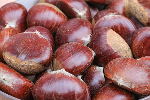 Ripe chestnuts close up. Sweet raw chestnuts. Husked chestnuts. Organic food. Food background. Healthy eating. Healthy lifestyle. Protein source. View from above. High quality photo