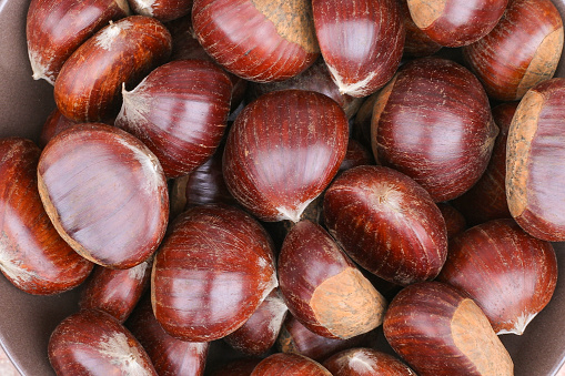 Ripe chestnuts close up. Sweet raw chestnuts. Husked chestnuts. Organic food. Food background. Healthy eating. Healthy lifestyle. Protein source. View from above. High quality photo