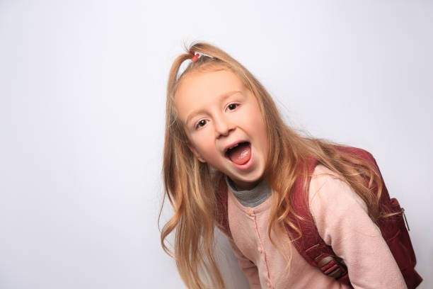 istock Emotional little girl with backpack on white background. Space for text 1820814153