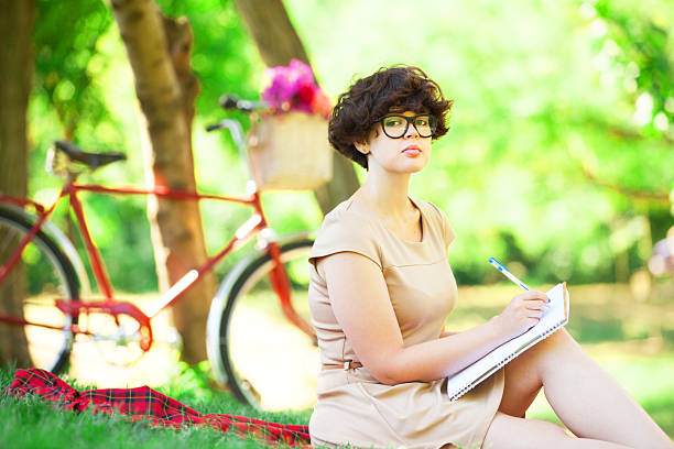 istock Brunette girl with note in the park. 182082968