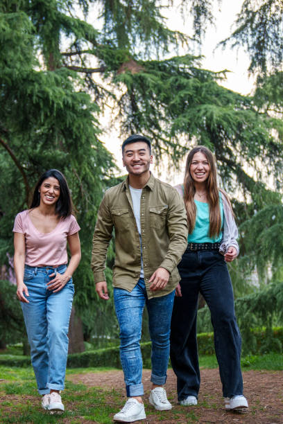 istock Three Friends Enjoying a Relaxed Walk in a Lush Park, Smiling 1820831607