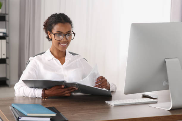 istock African American intern with folder working at table in office 1820832693